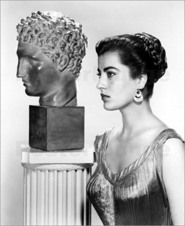 Greek actress Irene Pappas next to a Greek statue.