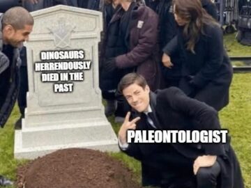 Paleontologist kneeling and smiling next to a tombstone that reads DINOSAURS HERRENDOUSLY DIED IN THE PAST