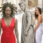 Woman in red dress standing next to a statue of Medusa