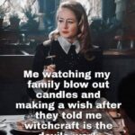 Woman in gothic style giving side-eye while family blows out birthday candles