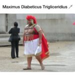 Overweight man in cheap Roman costume with plastic six-pack breastplate and toy sword